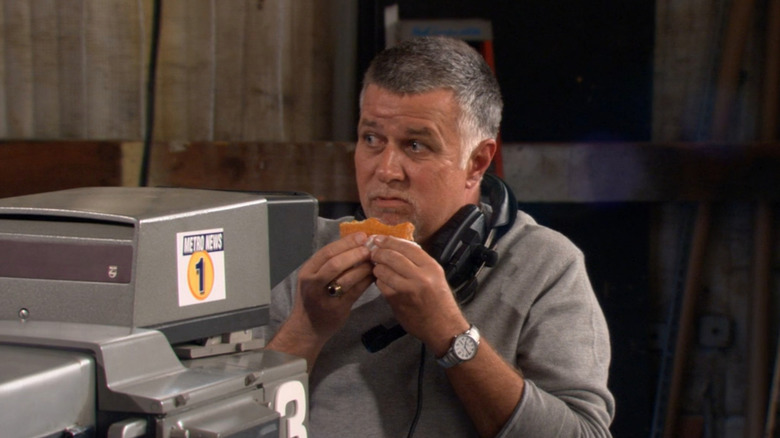 Ron Nicolosi as Mike eating a sandwich behind the camera in How I Met Your Mother
