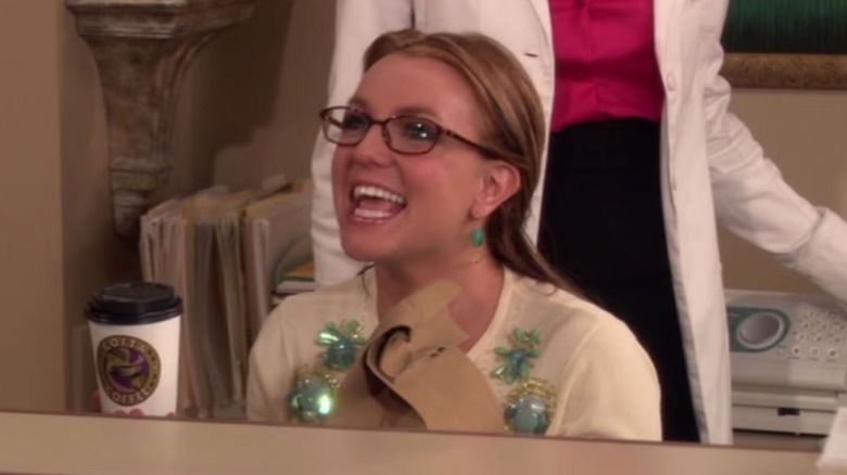 Abby (Britney Spears) sitting at a desk in "How I Met Your Mother"