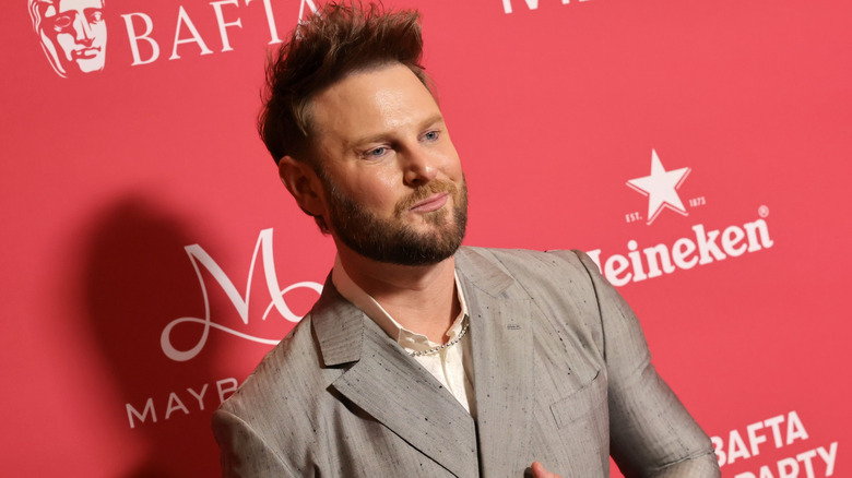 Bobby Berk posing for photographers at an event