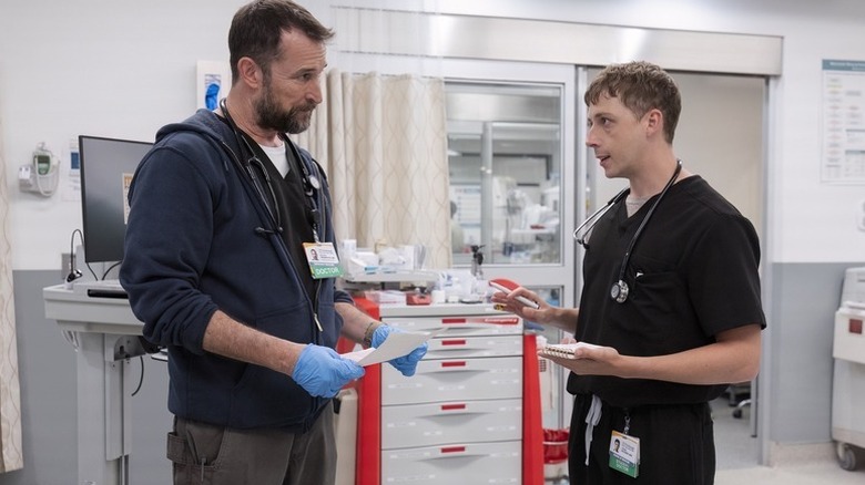 Dr. Robby and Whitaker standing across from each other