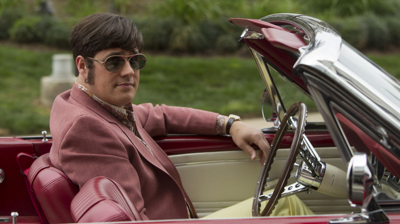 Harry Crane wearing a pink suit and sunglasses in a convertable car in "Mad Men" (2007)