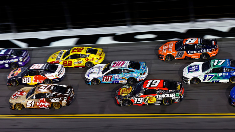 NASCAR Cup Series drivers racing at night at the 2025 Coke Zero Sugar 400