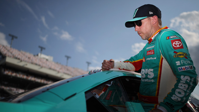 Denny Hamlin leaning out the window of his car at the Richmond Motor Speedway in 2026