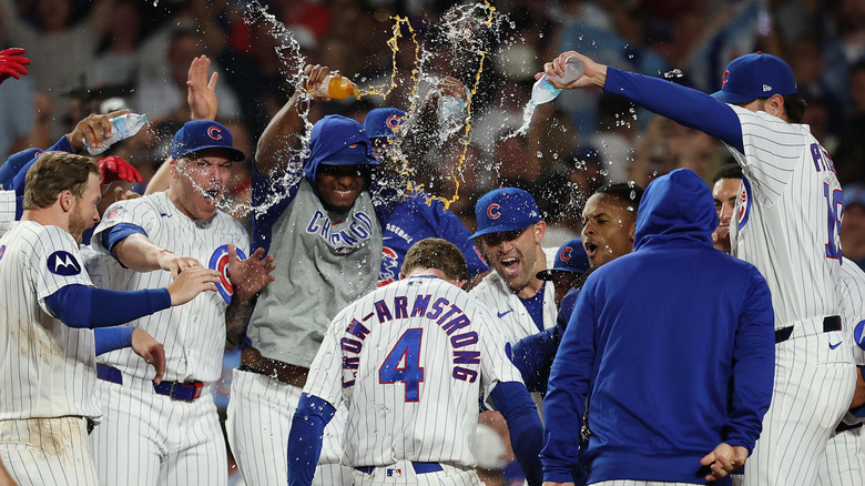 Teammates throwing water on Pete Crow-Armstrong