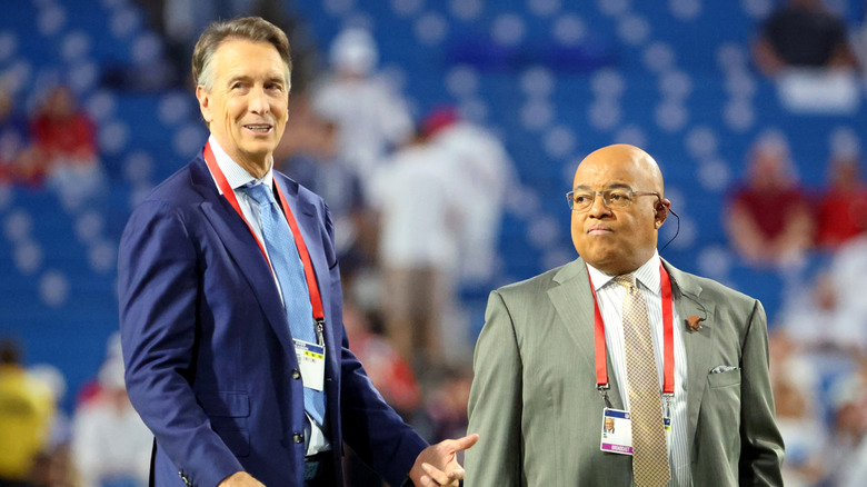 Mike Tirico and Chris Collinsworth prepare to call an NFL game