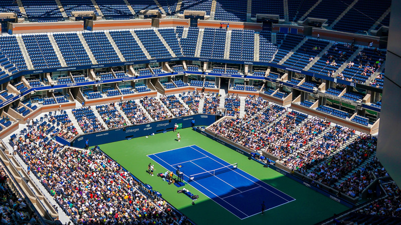 The inside of Arthur Ashe Stadium with a tennis court in New York