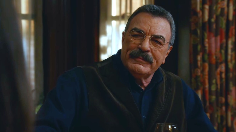 Frank Reagan seated at dinner table