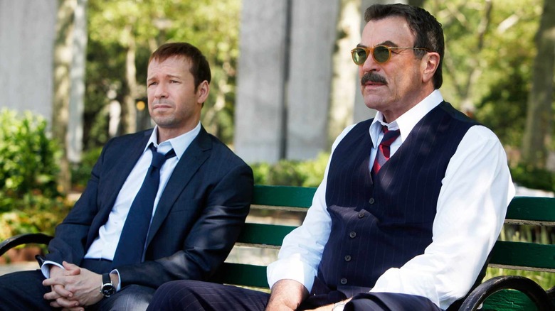 Detectives Danny and Frank Reagan, sitting on a park bench