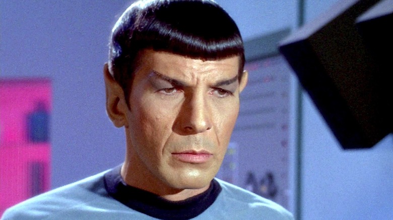 Mr. Spock looking very serious wearing a blue shirt in Star Trek