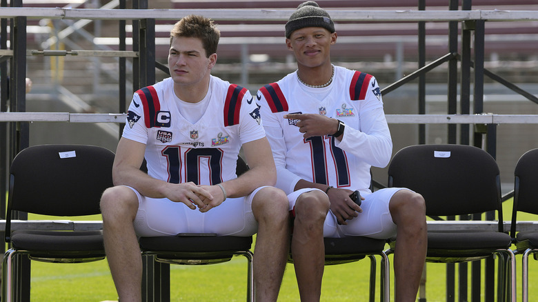two new england patriots players sitting on bench