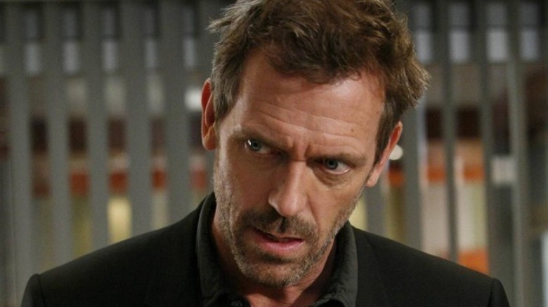 Hugh Laurie's Dr. Gregory House with a suspicious frown on his face on House