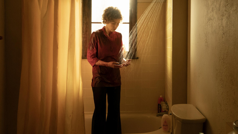 Candy (Jessica Biel) washing her hands fully clothed in the shower on Candy