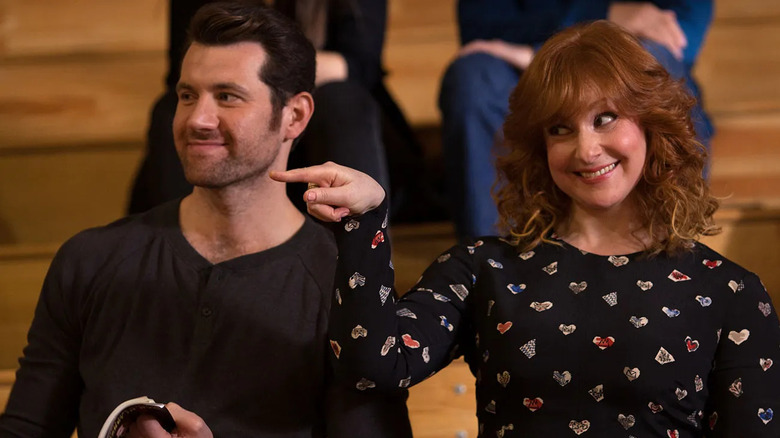 Billy (Billy Eichner) and Julie (Julie Klausner) smiling and pointing at someone on Difficult People