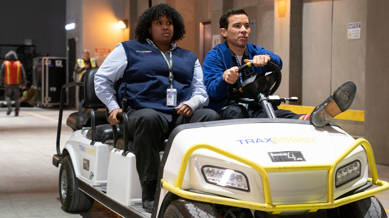 Mel (Natasha Rothwell) and Rory (Conrad Ricamora) driving in an airport shuttle cart on How to Die Alone