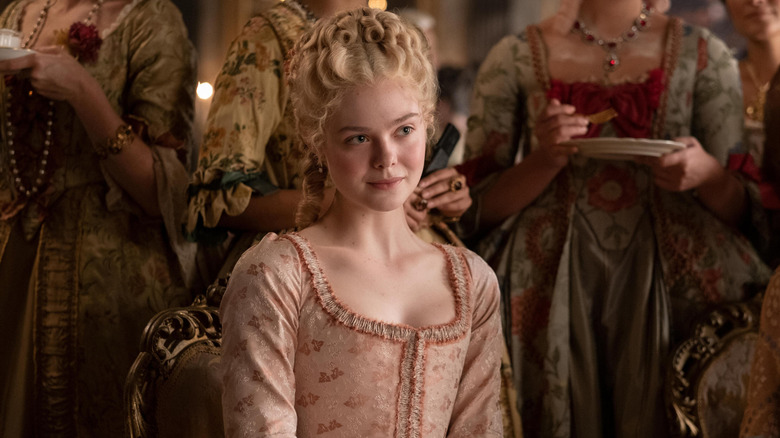 Catherine (Elle Fanning) with her ladies behind her smirking on The Great