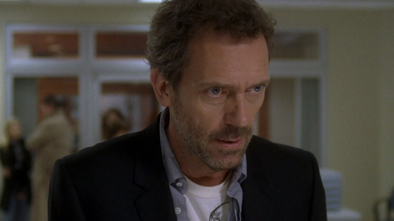 Hugh Laurie's Gregory House is seen standing in closeup in a hospital room in House