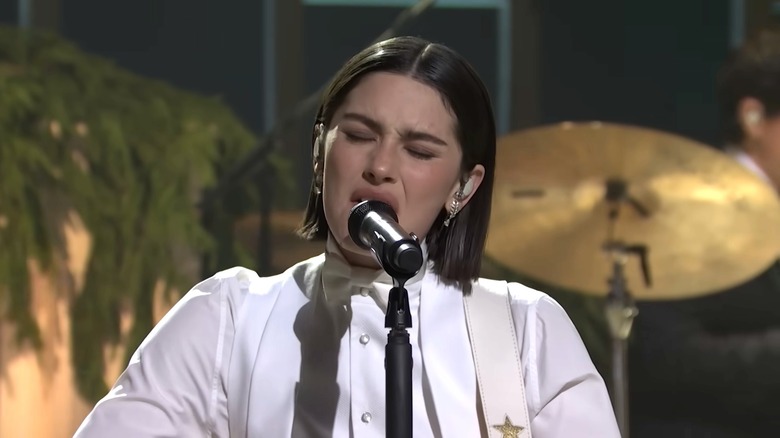Gracie Abrams singing into a mic on "Saturday Night Live."