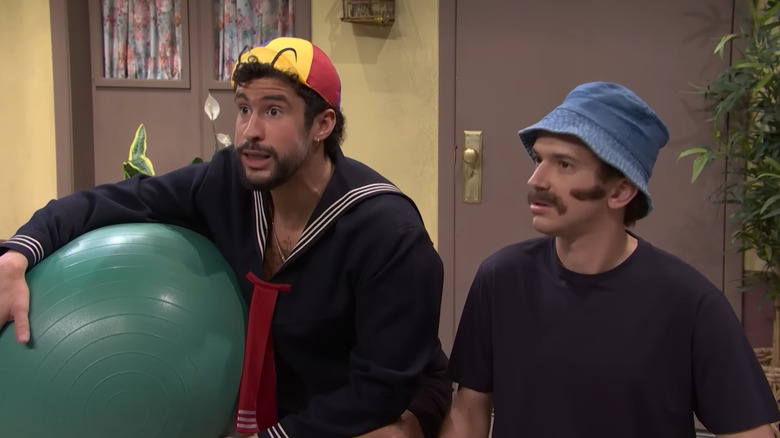 Bad Bunny and Andrew Dismukes sitting together on Saturday Night Live