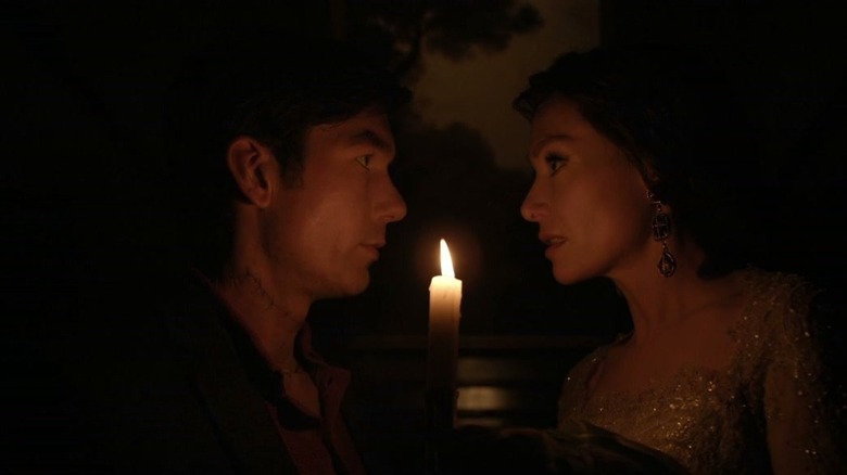 Harman e Lily se olhando à luz de velas 