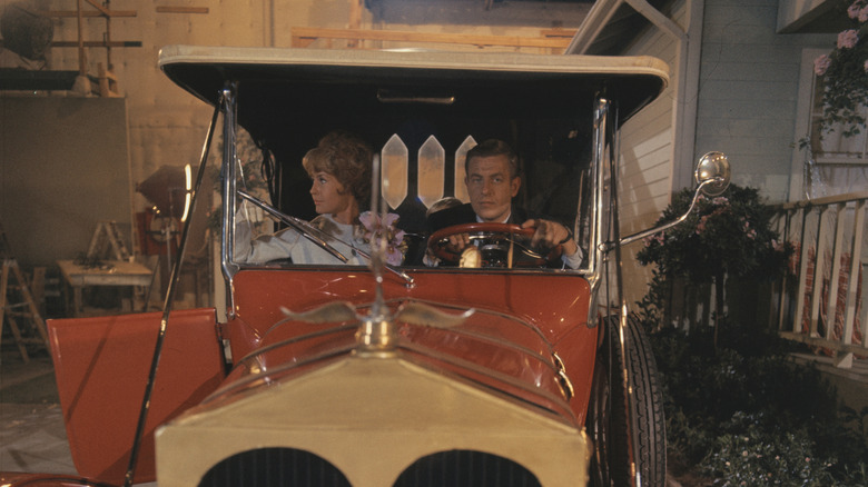 Barbara Crabtree (Maggie Pierce) and Dave Crabtree (Jerry Van Dyke) sitting in red 1928 car in "My Mother the Car"