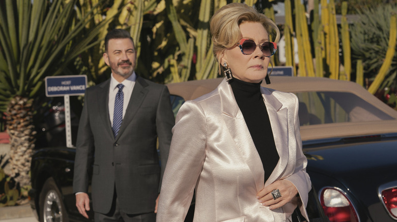 Jimmy Kimmel playing himself behind Deborah (Jean Smart) as she walks away on Hacks