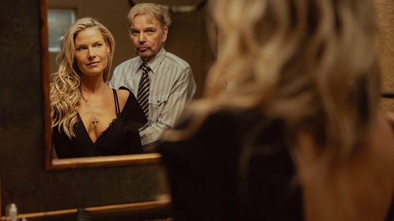 Ali Larter as Angela and Billy Bob Thornton as Tommy look at their reflection in a mirror in Landman