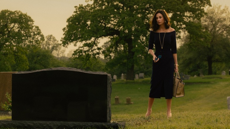 Demi Moore as Cami stands near a grave wearing a black dress on Landman