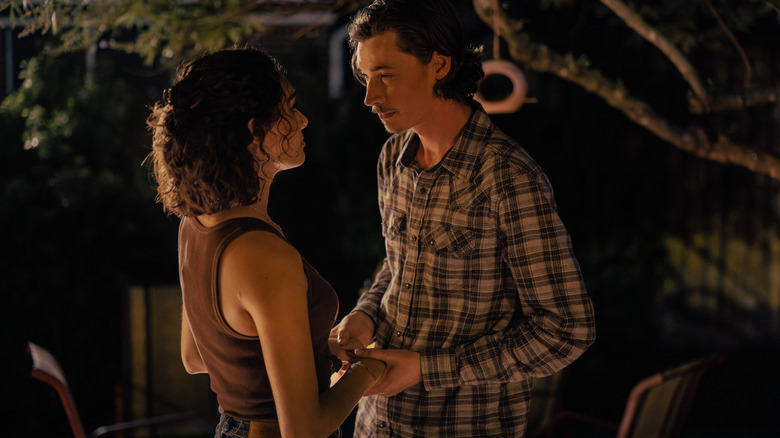 Paulina Chavez as Ariana and Jacob Lofland as Cooper hold hands in Landman