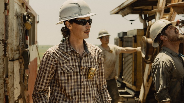 Jacob Lofland as Cooper Norris wears a hard hat and sunglasses at an oil well in Landman
