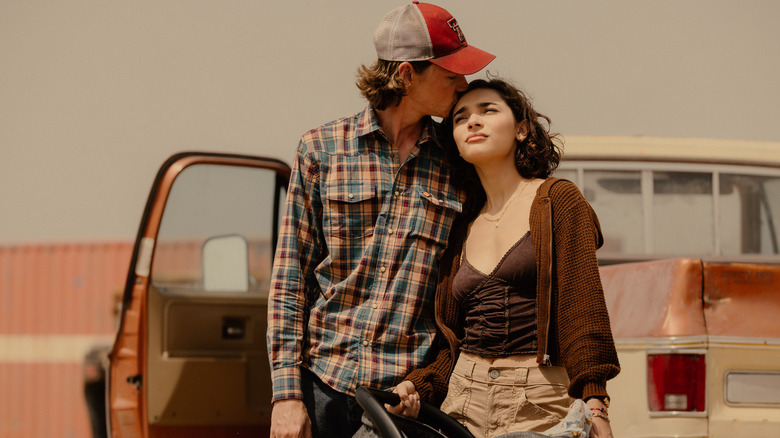 Cooper kisses Ariana on the head as they stand in front of a truck in Landman Season 2, Episode 1