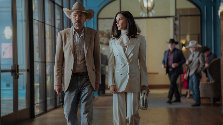 Tommy and Cami walk in a hallway in Landman Season 2, Episode 1