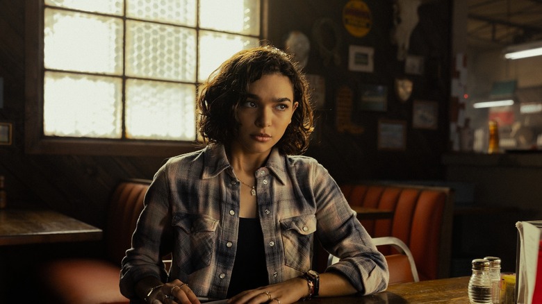 Paulina Chavéz as Ariana sits at a table filling out a form in Landman