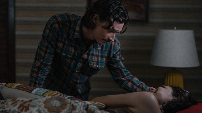 Jacob Lofland as Cooper bends over Paulina Chavez as Ariana as she lays in bed in Landman