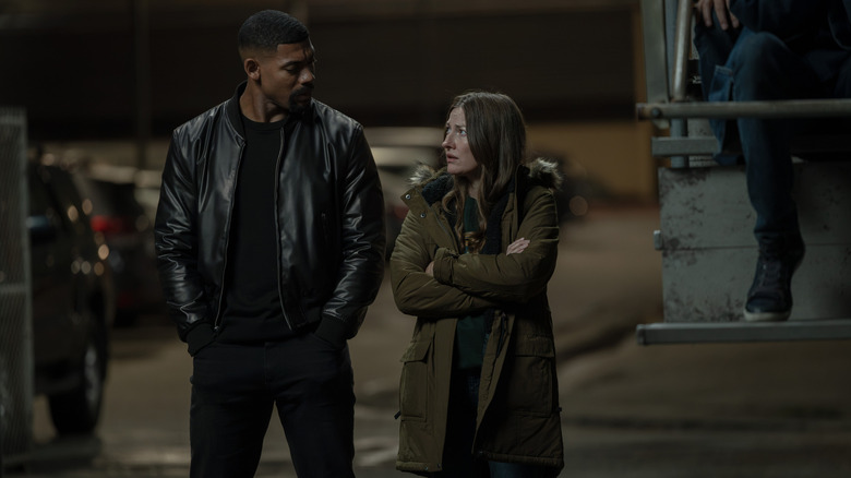 John and Kerry talking together in the street in "Lanterns" (2026)