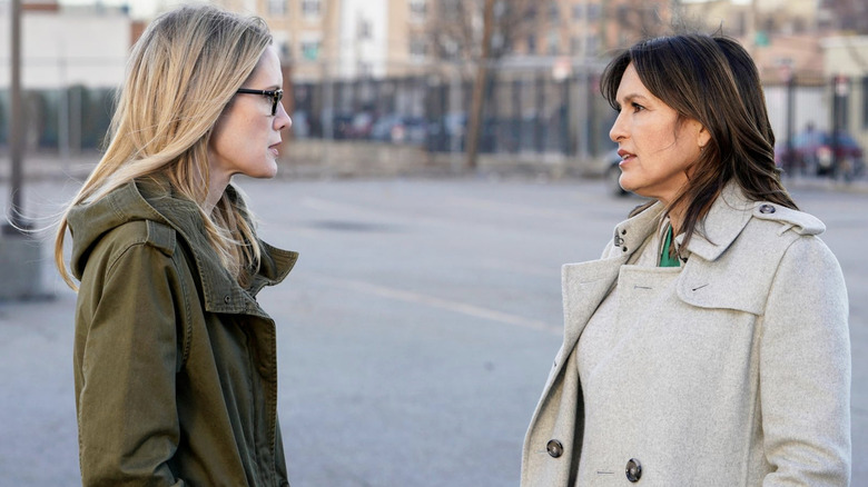 Alex Cabot in a green jacket and Olivia Benson in a white jacket facing each other in "Law & Order: SVU"