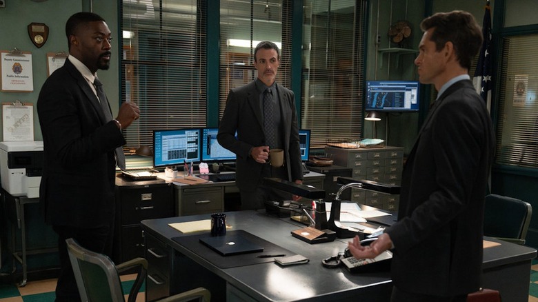 David Ajala as Theo Walker, Reid Scott as Det. Riley and Hugh Dancy as ADA Nolan Price look at each other in the police station on Law and Order