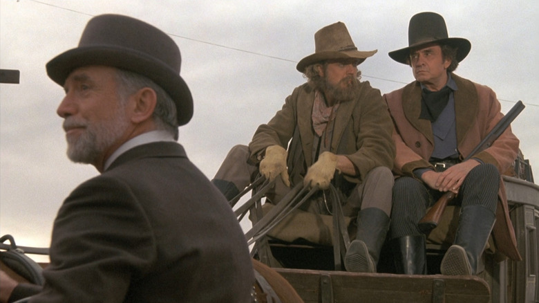 Doc Holliday and Ringo Kid sitting on their stagecoach in "Stagecoach" (1986)