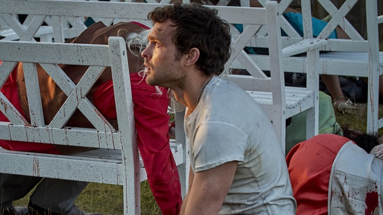 Alden Ehrenreich on his knees in despair in Brave New World