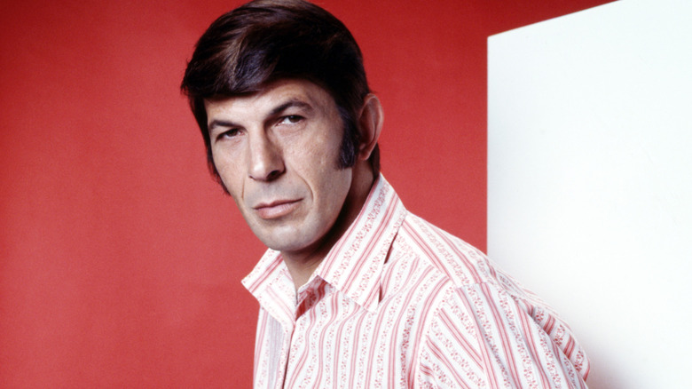 Leonard Nimoy posing against a white and red background