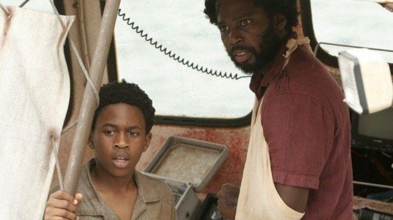 Walt and Michael look concerned as they look out from their makeshift boat