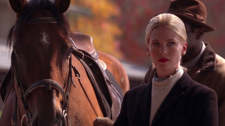 Betty Draper stands next to a horse in "Mad Men"
