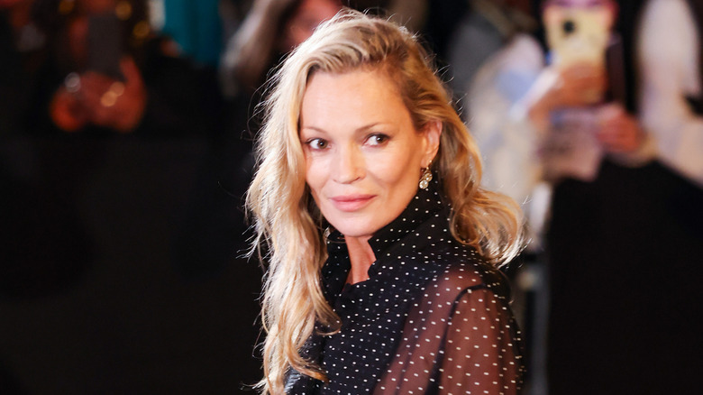 Kate Moss in a sheer black top with white polka dots