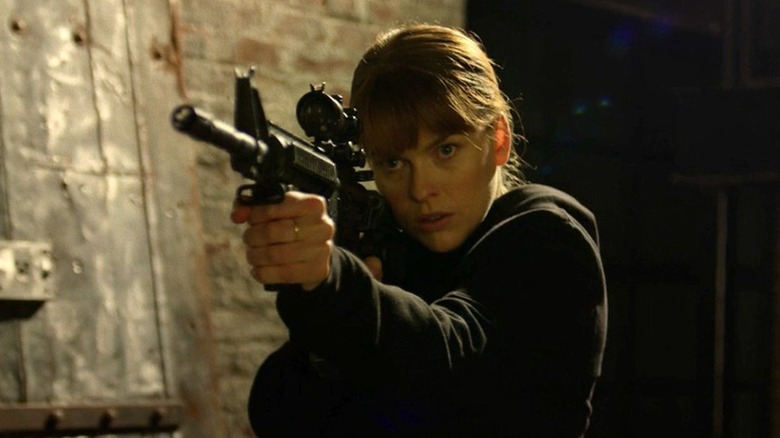 Alice Eve as Mary Alice Walker holding a gun on "Iron Fist"