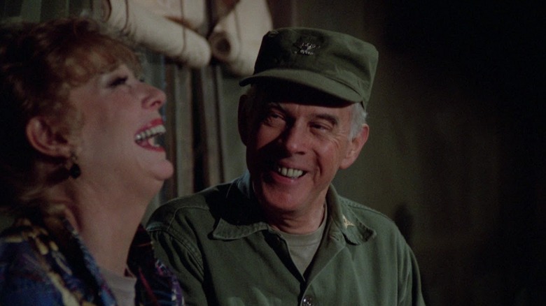 Brandy Doyle (Gwen Verdon) and Sherman Potter (Harry Morgan) laugh together in M*A*S*H