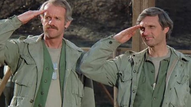 Benjamin Franklin Pierce and B.J. Hunnicutt salute on the set of M*A*S*H