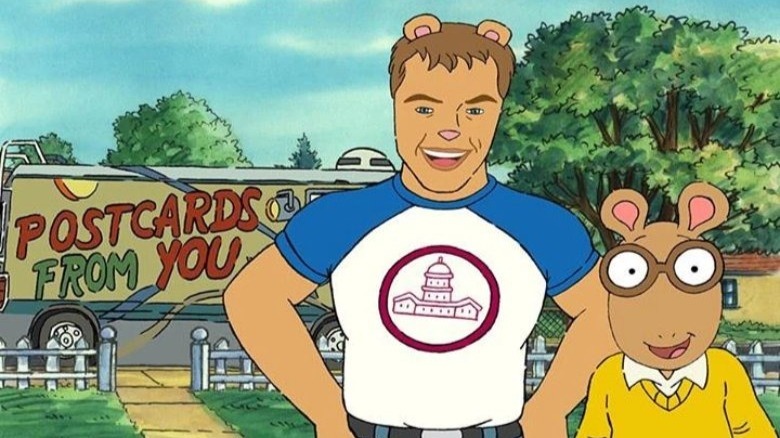 Matt Damon as a cartoon man-bear standing next to Arthur, smiling at the camera