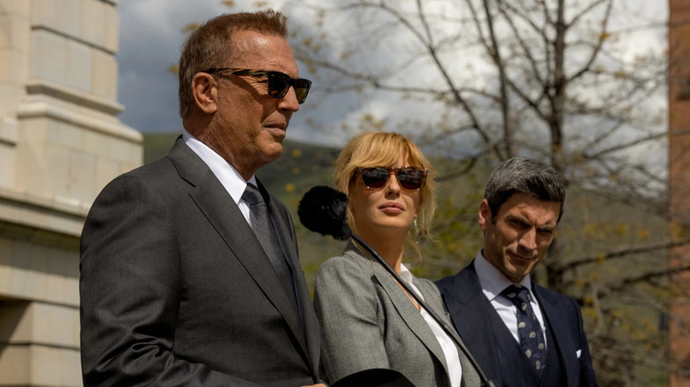 John (Kevin Costner), Beth (Kelly Reilly), and Jamie (Wes Bentley) standing next to each other on "Yellowstone"