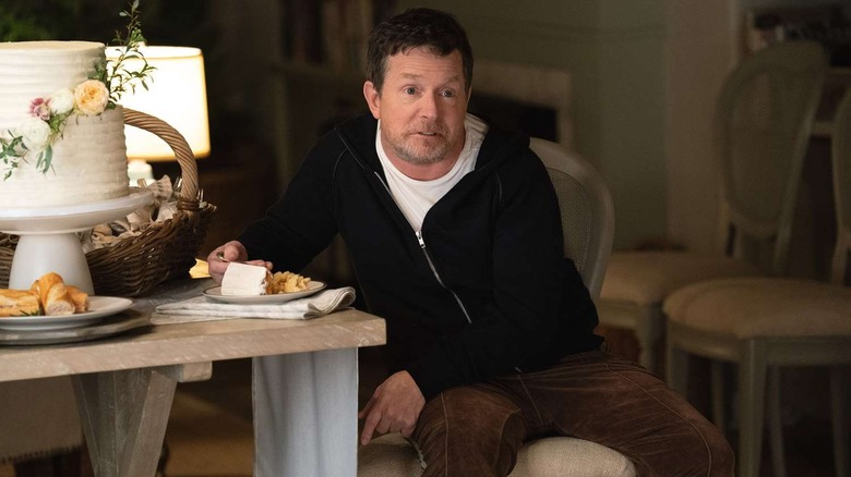 Gerry sitting at a table with cake on "Shrinking."