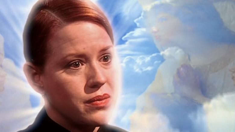 Molly Ringwald as Allison Channing giving a TV interview with a heavenly background behind her on "The Outer Limits" (1995)