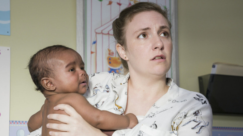 Lena Dunham as Hannah Horvath holding her charachter's child in the Girls series finale